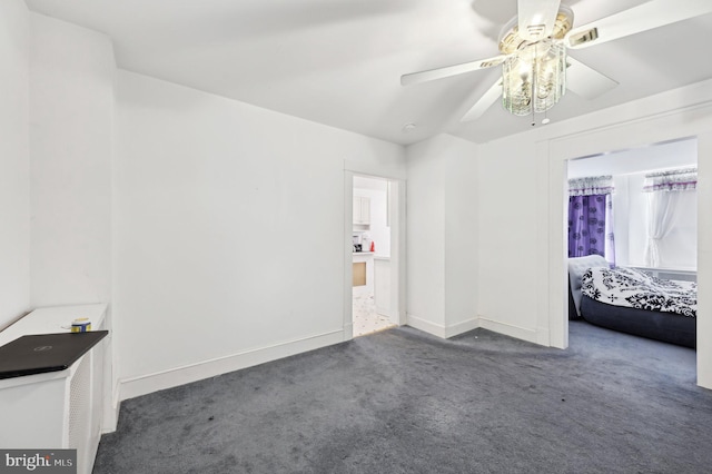 unfurnished bedroom featuring carpet flooring, baseboards, and ceiling fan