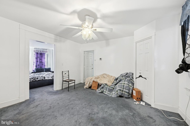 carpeted bedroom with ceiling fan and baseboards