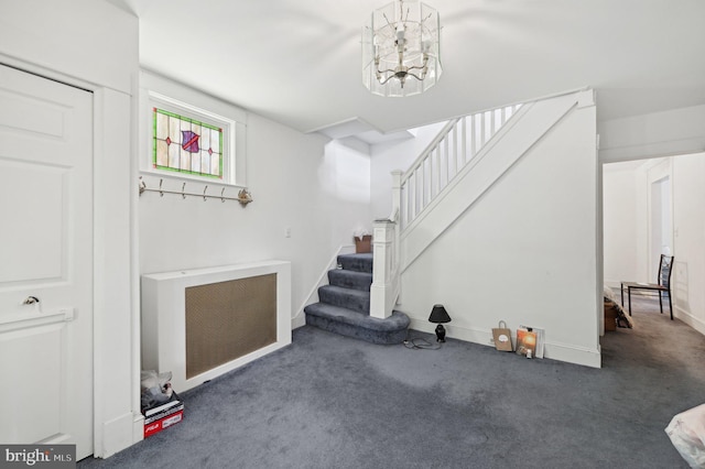 basement with stairway, a chandelier, carpet flooring, baseboards, and heating unit