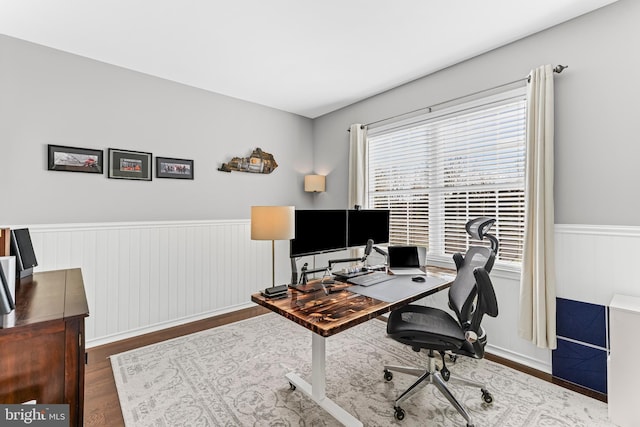 office area with wainscoting and wood finished floors