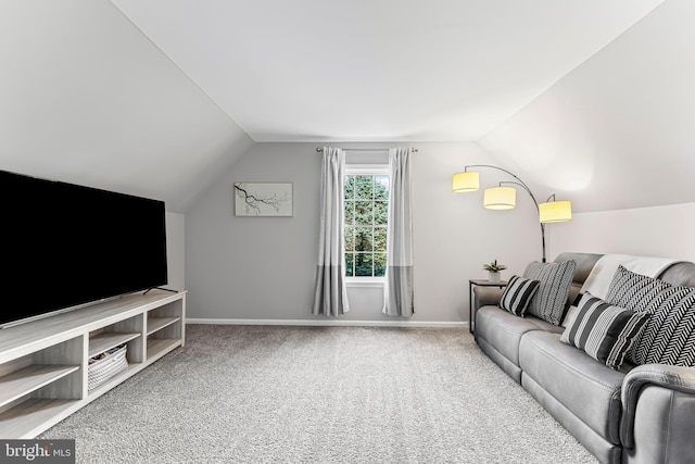 carpeted living room featuring vaulted ceiling and baseboards