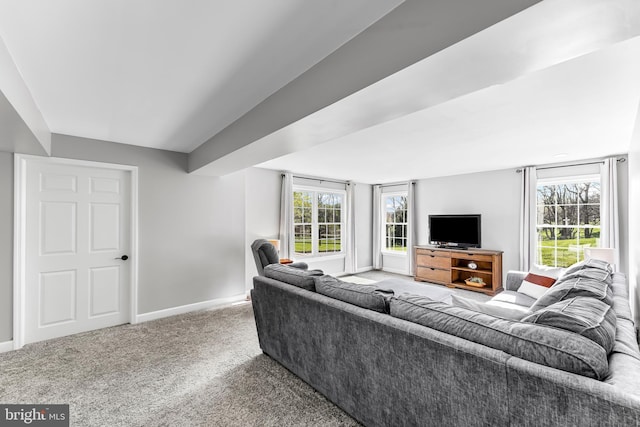 carpeted living room with baseboards