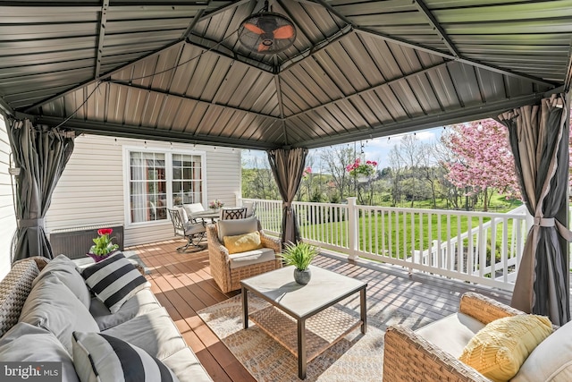 deck featuring a gazebo, an outdoor hangout area, and outdoor dining area