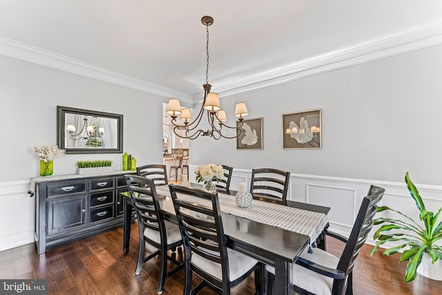 dining room featuring wainscoting, crown molding, a chandelier, and dark wood-style floors