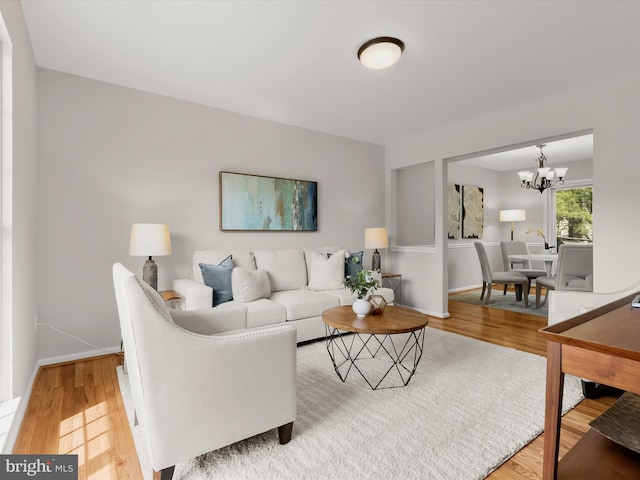 2607 Nisqually Ct, Silver Spring, MD 20906 - living area featuring an inviting chandelier, wood finished floors, and baseboards