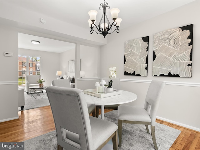 2607 Nisqually Ct, Silver Spring, MD 20906 - dining room with baseboards, wood finished floors, and an inviting chandelier
