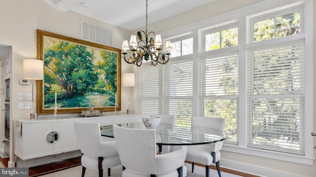 213 S Morris St, Oxford, MD 21654 - dining space with a chandelier, wood finished floors, and visible vents