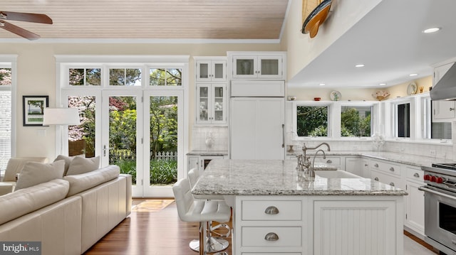 213 S Morris St, Oxford, MD 21654 - kitchen with high end stainless steel range, plenty of natural light, wooden ceiling, and a sink