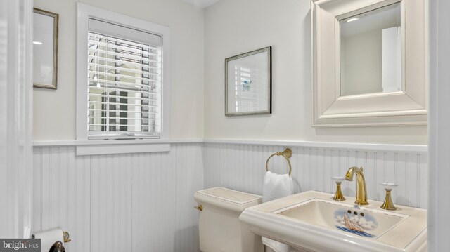 213 S Morris St, Oxford, MD 21654 - half bath featuring a wainscoted wall and a sink