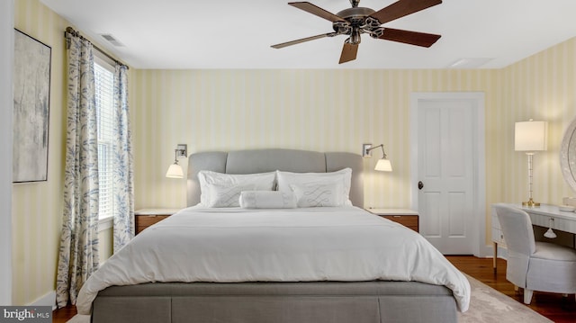 213 S Morris St, Oxford, MD 21654 - bedroom with visible vents, wallpapered walls, a ceiling fan, and wood finished floors
