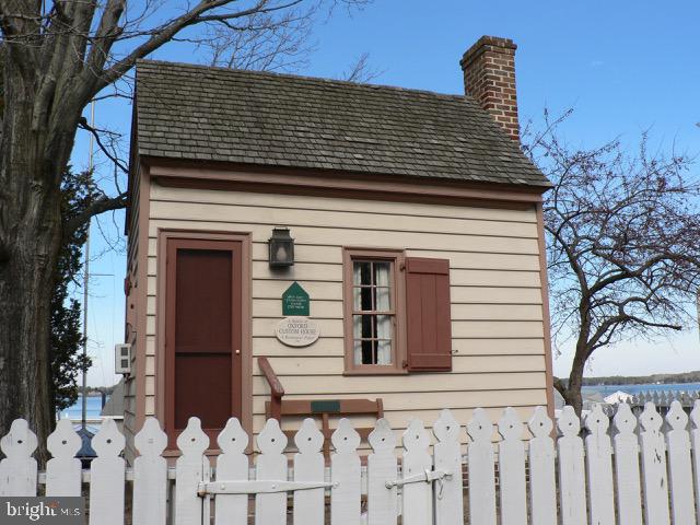 213 S Morris St, Oxford, MD 21654 - view of outbuilding featuring fence