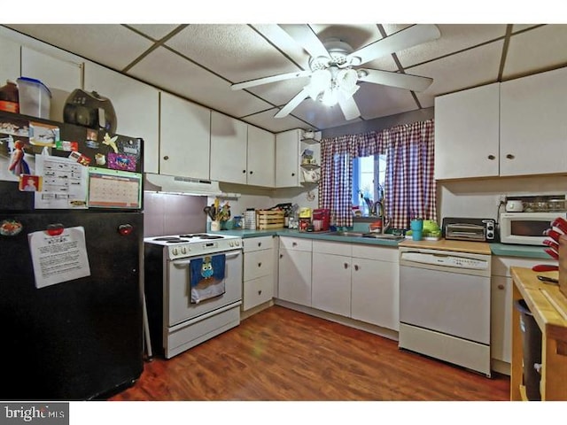 kitchen with a sink, under cabinet range hood, a ceiling fan, white appliances, and white cabinets