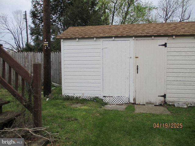 view of shed featuring fence