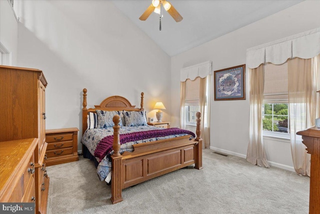 bedroom with light carpet, high vaulted ceiling, baseboards, and a ceiling fan