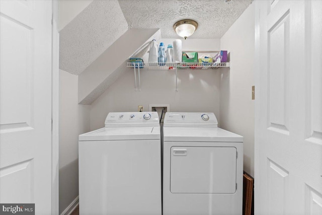 washroom with separate washer and dryer and a textured ceiling