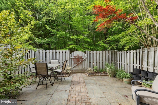 view of patio / terrace featuring a gate and outdoor dining area