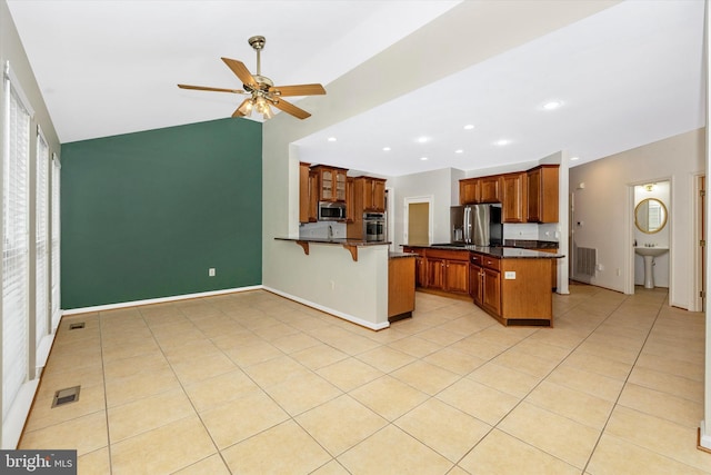430 Timbermill Run, Emmitsburg, MD 21727 - kitchen featuring stainless steel appliances, a peninsula, a kitchen bar, a ceiling fan, and brown cabinetry