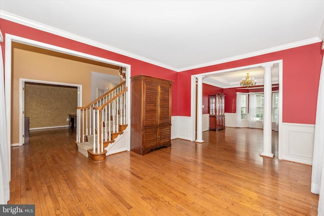 430 Timbermill Run, Emmitsburg, MD 21727 - unfurnished room with decorative columns, light wood-style flooring, a chandelier, stairs, and a wainscoted wall