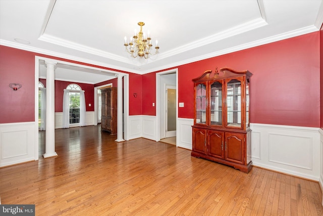 430 Timbermill Run, Emmitsburg, MD 21727 - unfurnished room featuring a raised ceiling, light wood-type flooring, a chandelier, ornate columns, and wainscoting