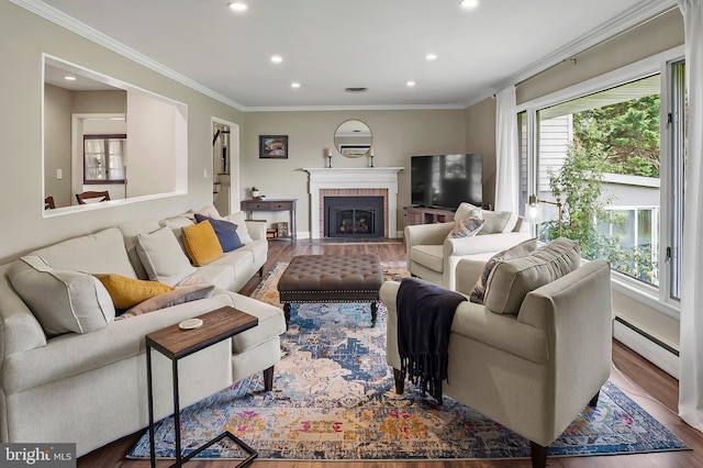 2609 Turf Valley Rd, Ellicott City, MD 21042 - living room with crown molding, a brick fireplace, recessed lighting, wood finished floors, and a baseboard heating unit