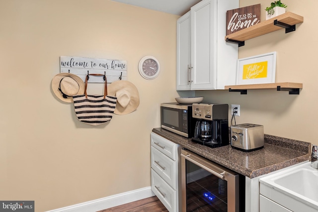 2609 Turf Valley Rd, Ellicott City, MD 21042 - kitchen featuring open shelves, a sink, beverage cooler, white cabinetry, and stainless steel microwave