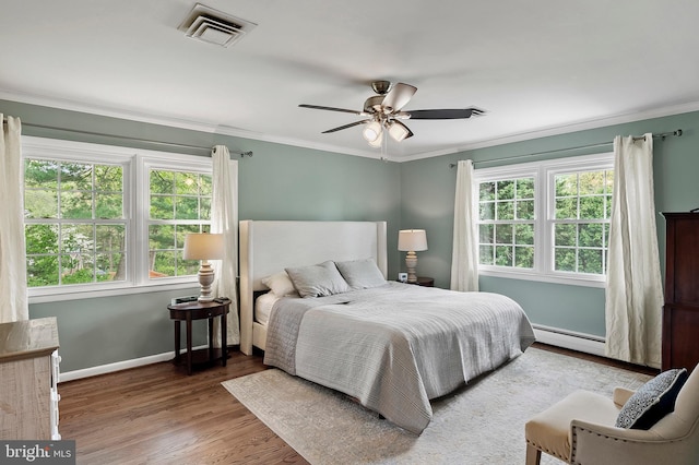 2609 Turf Valley Rd, Ellicott City, MD 21042 - bedroom featuring visible vents, crown molding, wood finished floors, baseboards, and baseboard heating