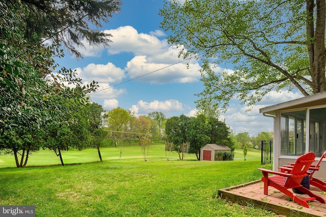 2609 Turf Valley Rd, Ellicott City, MD 21042 - view of yard featuring a sunroom, an outdoor structure, and a storage shed