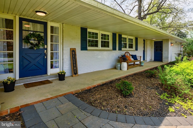 2609 Turf Valley Rd, Ellicott City, MD 21042 - doorway to property featuring covered porch and brick siding