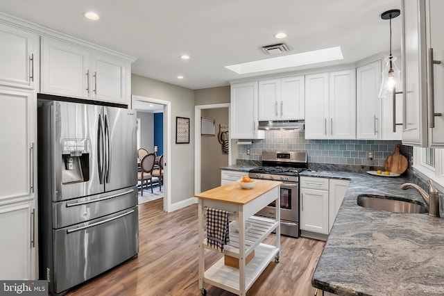 2609 Turf Valley Rd, Ellicott City, MD 21042 - kitchen with a skylight, appliances with stainless steel finishes, light wood-style floors, and visible vents