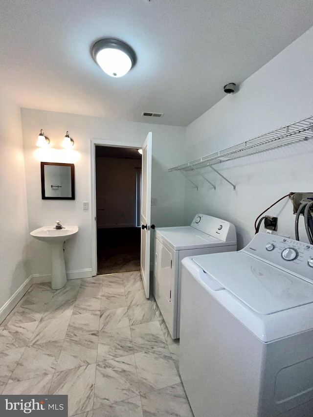 4658 Winterberry Ln, Oxon Hill, MD 20745 - laundry room with washer and clothes dryer, light marble finish floors, and baseboards