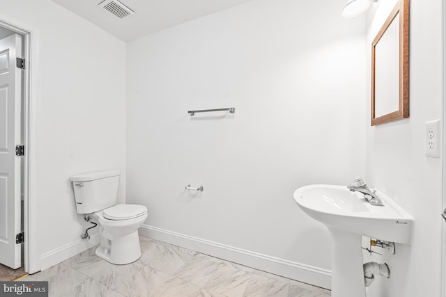 4658 Winterberry Ln, Oxon Hill, MD 20745 - half bath with marble look tile flooring, toilet, and baseboards