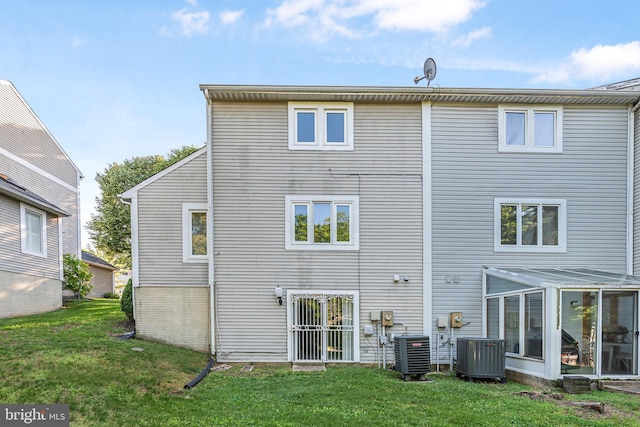 4658 Winterberry Ln, Oxon Hill, MD 20745 - rear view of property with central air condition unit, a yard, and a sunroom