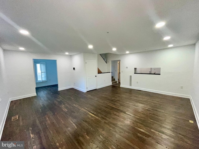 4658 Winterberry Ln, Oxon Hill, MD 20745 - unfurnished living room featuring dark wood-style flooring, stairs, recessed lighting, and baseboards