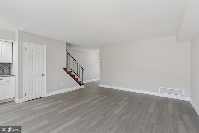 102 Orchard Ct, Royersford, PA 19468 - unfurnished living room with light wood finished floors, stairs, and baseboards
