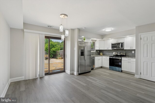 102 Orchard Ct, Royersford, PA 19468 - kitchen with appliances with stainless steel finishes, backsplash, light stone counters, and light wood-type flooring