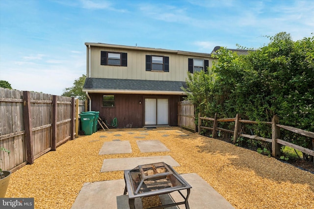 102 Orchard Ct, Royersford, PA 19468 - back of house featuring an outdoor fire pit, a fenced backyard, roof with shingles, and a patio