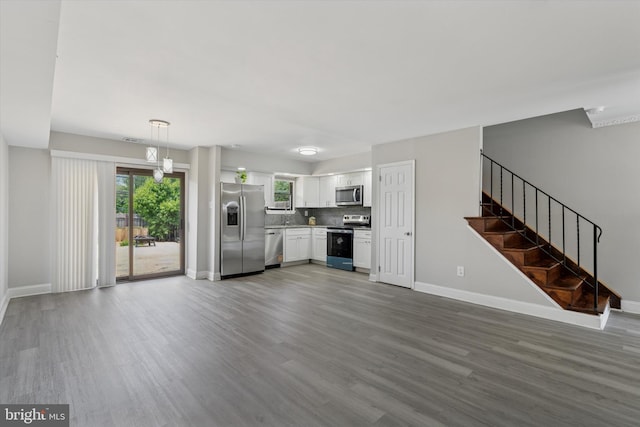 102 Orchard Ct, Royersford, PA 19468 - unfurnished living room featuring wood finished floors, baseboards, and stairway