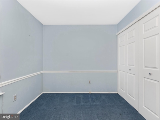 7250 Single Wheel Path, Columbia, MD 21046 - unfurnished bedroom with dark carpet, a closet, and baseboards