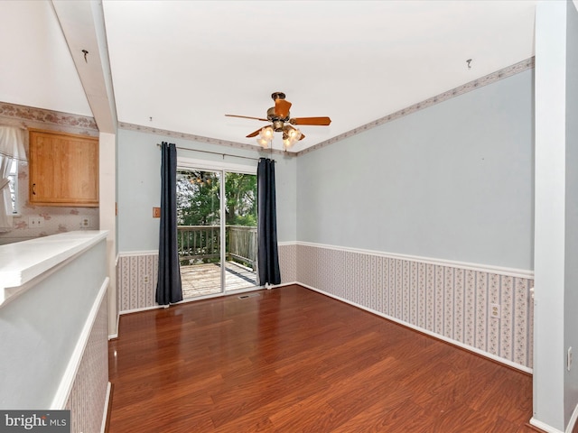 7250 Single Wheel Path, Columbia, MD 21046 - unfurnished living room featuring wood finished floors, wallpapered walls, wainscoting, and ceiling fan