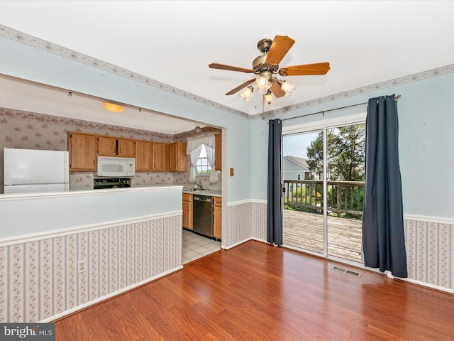7250 Single Wheel Path, Columbia, MD 21046 - kitchen with white appliances, wallpapered walls, a sink, light wood-type flooring, and light countertops