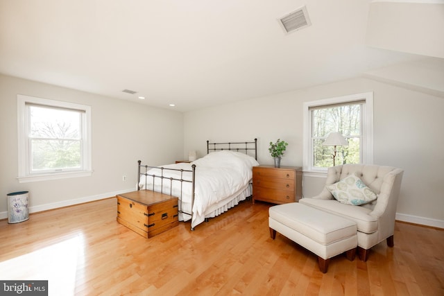 bedroom with baseboards, visible vents, and light wood-type flooring