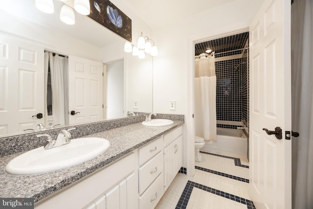 full bath featuring double vanity, toilet, tile patterned floors, and a sink
