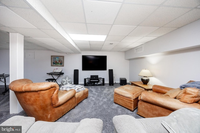 living area featuring baseboards, carpet, and a paneled ceiling