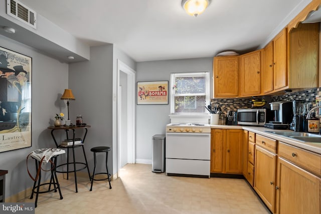 424 Hillside Rd, New Cumberland, PA 17070 - kitchen featuring visible vents, white range oven, a sink, stainless steel microwave, and light floors