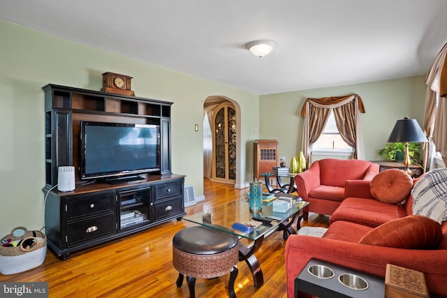 424 Hillside Rd, New Cumberland, PA 17070 - living area with arched walkways, visible vents, and wood finished floors