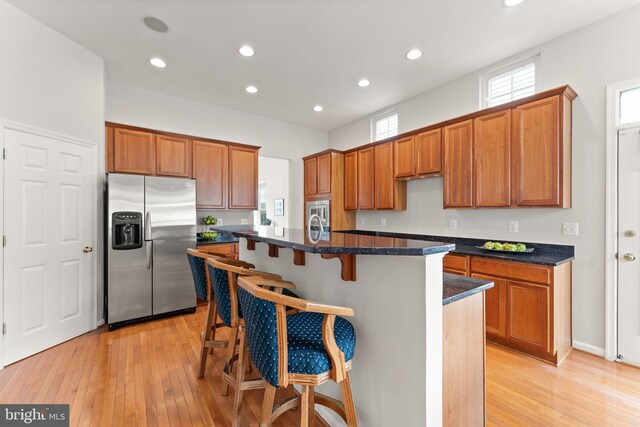 17435 Lethridge Cir, Round Hill, VA 20141 - kitchen featuring stainless steel fridge, recessed lighting, light wood-style flooring, brown cabinets, and a breakfast bar