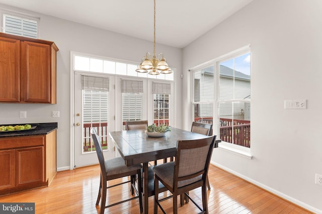 17435 Lethridge Cir, Round Hill, VA 20141 - dining area with baseboards, light wood-type flooring, and a chandelier
