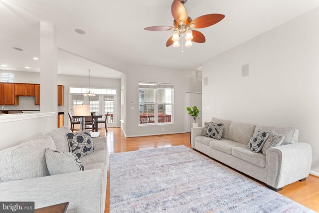 17435 Lethridge Cir, Round Hill, VA 20141 - living room with a ceiling fan, light wood finished floors, recessed lighting, a chandelier, and baseboards