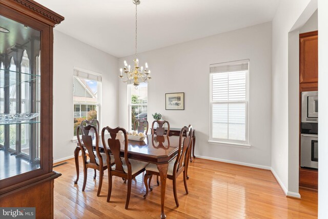 17435 Lethridge Cir, Round Hill, VA 20141 - dining area featuring light wood-style floors, healthy amount of natural light, and a chandelier