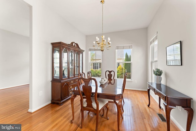 17435 Lethridge Cir, Round Hill, VA 20141 - dining area featuring light wood-type flooring, a chandelier, and baseboards
